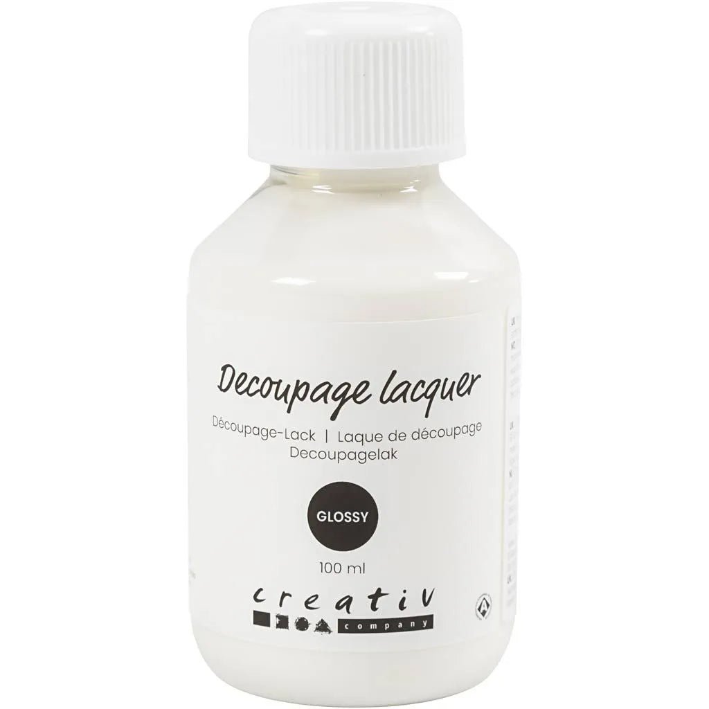 Decoupagelack - 100 ml - Glossy från Creative Company. Liten vit flaska som det står Decoupage lacquer Glossy på. Tidformera